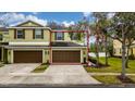 Two-story townhome with double garage and landscaped yard at 8609 Fiddleleaf Ct, Tampa, FL 33647