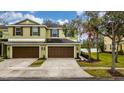 Front view of a two-story townhome with double garage at 8609 Fiddleleaf Ct, Tampa, FL 33647