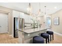 Modern kitchen with island, stainless steel appliances, and stylish pendant lighting at 9093 Players Dr, Weeki Wachee, FL 34613