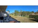 Spacious backyard with a fenced area and trees at 13 Pebble Beach Rd, Rotonda West, FL 33947