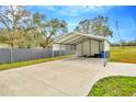 Detached metal carport with plenty of space, offering sheltered parking and storage solutions on a concrete pad at 8600 W Knights Griffin Rd, Plant City, FL 33565