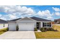 Two-car garage and front entrance at 9415 Pinewood Point Pl, Seffner, FL 33584