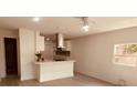 Modern kitchen featuring white cabinets, stainless steel appliances, and an island at 5809 N 17Th St, Tampa, FL 33610