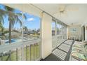 Enclosed lanai with large windows offering community and pool views and multiple seating options at 6594 Fairway Gardens Dr # 6594, Bradenton, FL 34203