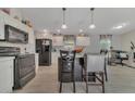 Bright kitchen features stainless steel appliances, an island and stylish pendant lighting at 13107 Texel Ave, New Port Richey, FL 34654