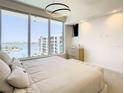 Modern main bedroom with large windows offering waterfront and building views at 900 N Osceola Ave # 703, Clearwater, FL 33755