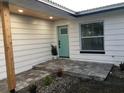 Renovated front entry with light teal door and gray pavers at 15810 2Nd E St, Redington Beach, FL 33708