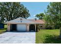 One-story home with carport and spacious yard at 6136 Fairway Dr, Ridge Manor, FL 33523