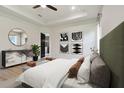 This bedroom is spacious and features modern decor, a sitting area, and an ensuite bathroom at 4327 Glendon Pl, Valrico, FL 33596