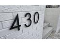 Modern house number 430 on a white brick wall at 430 Columbia Dr, Tampa, FL 33606