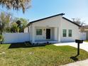 Newly built home with white exterior, fenced yard, and driveway at 206 S Water St, Plant City, FL 33563