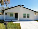 Charming white house with a modern design and well-maintained landscaping at 206 S Water St, Plant City, FL 33563