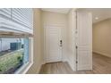 Bright entryway with white door and neutral-toned tile flooring at 18265 Vizcaya Ct, Venice, FL 34293