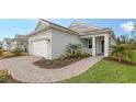 One-story home showcasing a white garage door and well-maintained landscaping at 18265 Vizcaya Ct, Venice, FL 34293