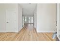 Bright entryway with light hardwood floors and neutral walls at 1939 W Arch St, Tampa, FL 33607