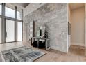 Bright entryway with stone wall and modern console table at 9586 Troutwater Ln, Tampa, FL 33618