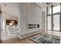 Open living area showcasing a linear fireplace and hardwood floors at 9586 Troutwater Ln, Tampa, FL 33618