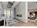 Open living space with modern fireplace and large windows at 9586 Troutwater Ln, Tampa, FL 33618