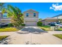 Two-story house with a two-car garage and landscaped front yard at 17035 Peaceful Valley Dr, Wimauma, FL 33598