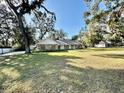 House exterior showcasing landscaping and a large yard at 1501 Buell Ct, Plant City, FL 33567