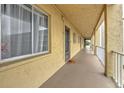 Building hallway with light yellow walls and individual condo entrances at 3753 Lake Bayshore Dr # H305, Bradenton, FL 34205