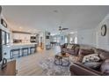 Open living area with kitchen, leather couches, and pool table at 909 Birdie Way, Apollo Beach, FL 33572