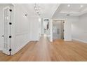 Open floor plan with hardwood floors, white walls, and modern lighting fixtures at 4010 W Watrous Ave, Tampa, FL 33629