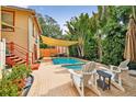 Refreshing backyard pool with lounge chairs and shade sail at 704 S Newport Ave, Tampa, FL 33606