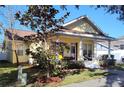 Charming yellow home with a cozy front porch and well-manicured lawn at 3639 Hurston St, New Port Richey, FL 34655