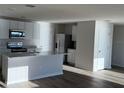 Modern kitchen with white cabinets, marble countertops, and stainless steel appliances at 10225 Kalamazoo Pl, Parrish, FL 34219