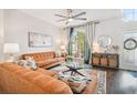 Cozy living room showcasing an orange couch and large windows at 20233 Still Wind Dr, Tampa, FL 33647