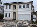 Two-story home with white and beige exterior, two-car garage, and a paved driveway at 3707 W San Juan St, Tampa, FL 33629