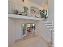 Modern staircase with white railings, leading to an open loft area; view of a home office at 4334 Sanddollar Ct, New Port Richey, FL 34652