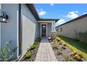 House exterior showcasing a walkway to the front door and landscaping at 3778 Maxwell Park Dr, Sun City Center, FL 33573