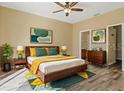 Bright bedroom with a king-size bed and wood floors at 5723 Autumn Shire Dr, Zephyrhills, FL 33541