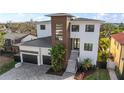 Stunning two-story modern home showcasing a two-car garage and a striking staircase entrance at 5006 W San Miguel St, Tampa, FL 33629
