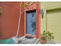 Modern gray front door with a red brick accent wall at 212 S Moody Ave # 2, Tampa, FL 33609