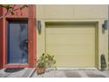Attached garage with light yellow door and modern lighting at 212 S Moody Ave # 2, Tampa, FL 33609