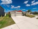 One-story house with a two-car garage and large driveway at 11818 Tetrafin Dr, Riverview, FL 33579