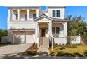 Two-story white house with a gray roof, and a landscaped yard at 3011 W Asbury Pl, Tampa, FL 33611