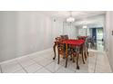 Dining room featuring tile flooring, chandelier, and mirrored wall at 3114 Lake Pine Way # H2, Tarpon Springs, FL 34688