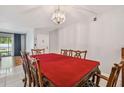 Cozy dining area featuring traditional wood furniture and modern lighting at 3114 Lake Pine Way # H2, Tarpon Springs, FL 34688