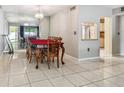 Traditional dining room with tiled floor, ornate wood table, and mirrored wall at 3114 Lake Pine Way # H2, Tarpon Springs, FL 34688