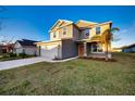 Two-story house with gray siding, white garage door, and a well-maintained lawn at 16134 69Th Lane East, Parrish, FL 34219