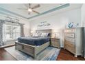 Main bedroom with a king-size bed and gray dresser at 6843 Boulder Run Loop, Wesley Chapel, FL 33545