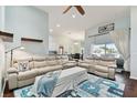 Spacious living room featuring light beige couches and a decorative rug at 6843 Boulder Run Loop, Wesley Chapel, FL 33545