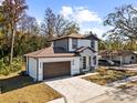 Two-story house with brown roof, white walls, and a brown door at 8119 N Dakota, Tampa, FL 33604