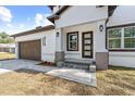 Front entrance with gray brick, brown door and a paved walkway at 8119 N Dakota, Tampa, FL 33604