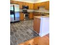 Kitchen featuring stainless steel appliances, granite countertops, and hexagon tile floors at 277 Valencia Cir, St Petersburg, FL 33716