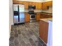 Kitchen featuring stainless steel appliances, granite countertops, and hexagon tile floors at 277 Valencia Cir, St Petersburg, FL 33716